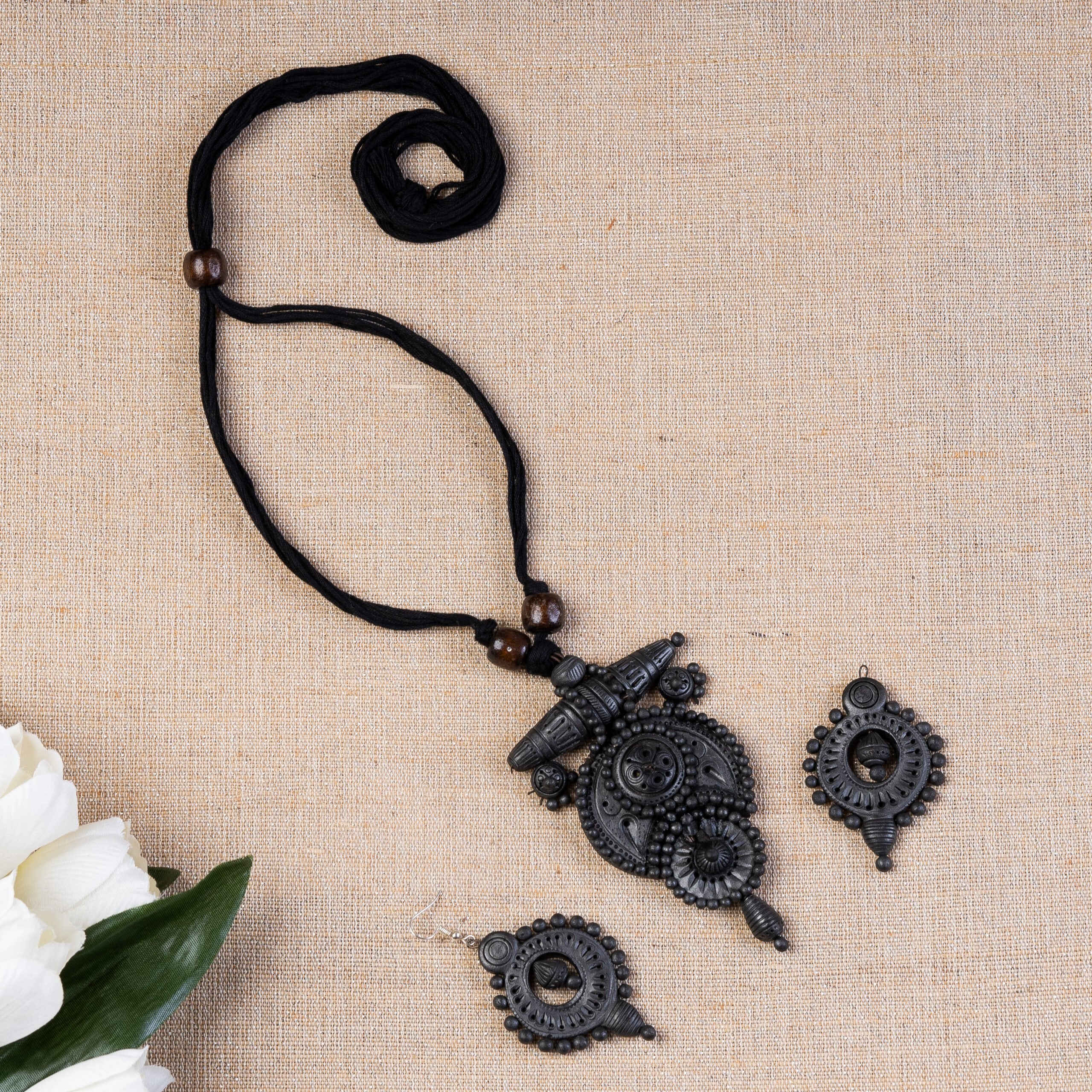 Petal-sculpted terracotta shrine pendant