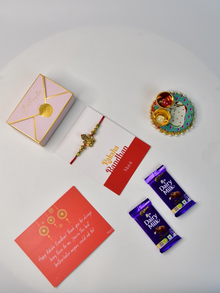 Sowpeace Exquisite Golden Ganesha Rakhi Pack of 1 with Roli Chawal Thali, Chocolates, and Greeting card combo for Raksha Bandhan and Gifting