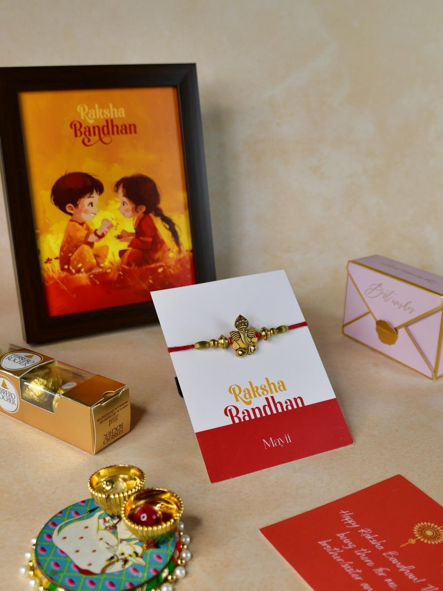 Sowpeace Exquisite Golden Ganesha Rakhi Pack of 1 with Roli Chawal Thali, Chocolates, Photo Frame and Greeting card combo for Raksha Bandhan and Gifting