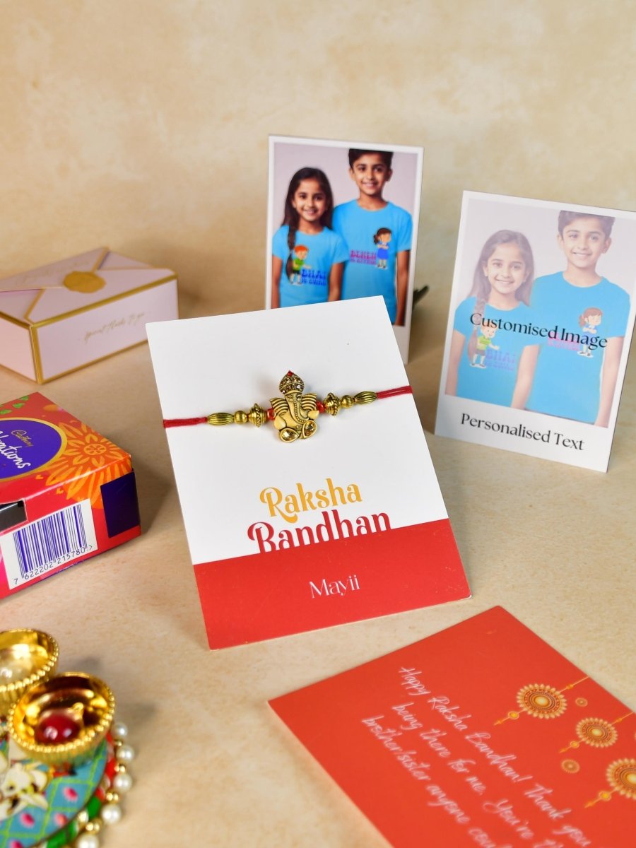 Sowpeace Exquisite Golden Ganesha Rakhi Pack of 1 with Roli Chawal Thali, Chocolates, Poloroids and Greeting card combo for Raksha Bandhan and Gifting