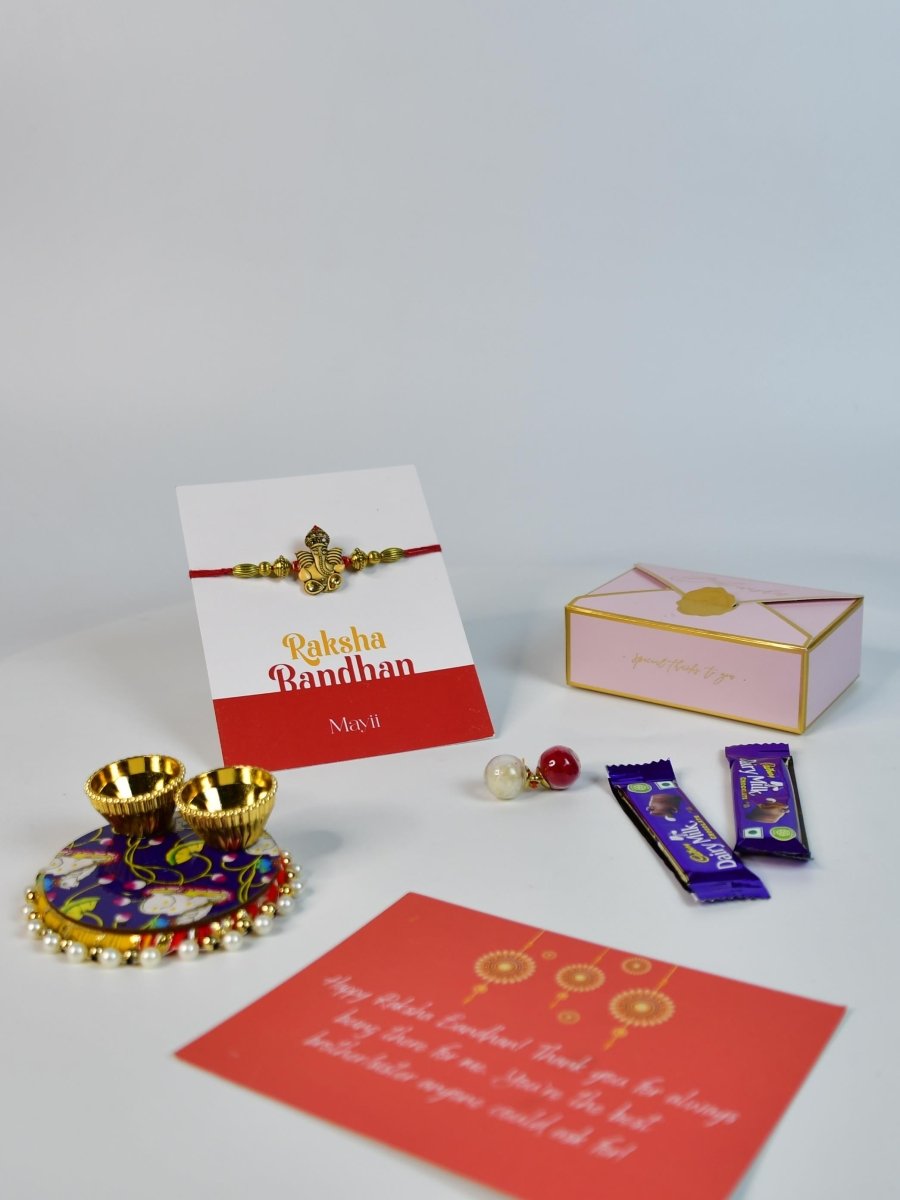 Sowpeace Exquisite Golden Ganesha Rakhi Pack of 1 with Roli Chawal Thali, two Chocolates, and Greeting card combo for Raksha Bandhan and Gifting