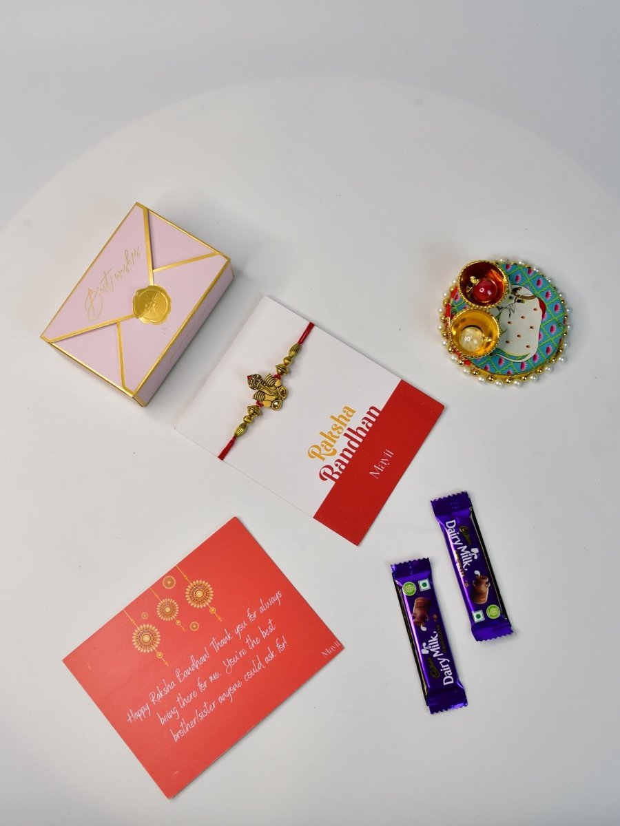 Sowpeace Exquisite Golden Ganesha Rakhi Pack of 1 with Roli Chawal Thali, two Chocolates, and Greeting card combo for Raksha Bandhan and Gifting